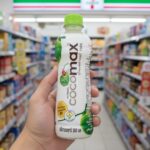 A bottle of Cocomax 100% Coconut Water held inside a Thai 7-Eleven store.