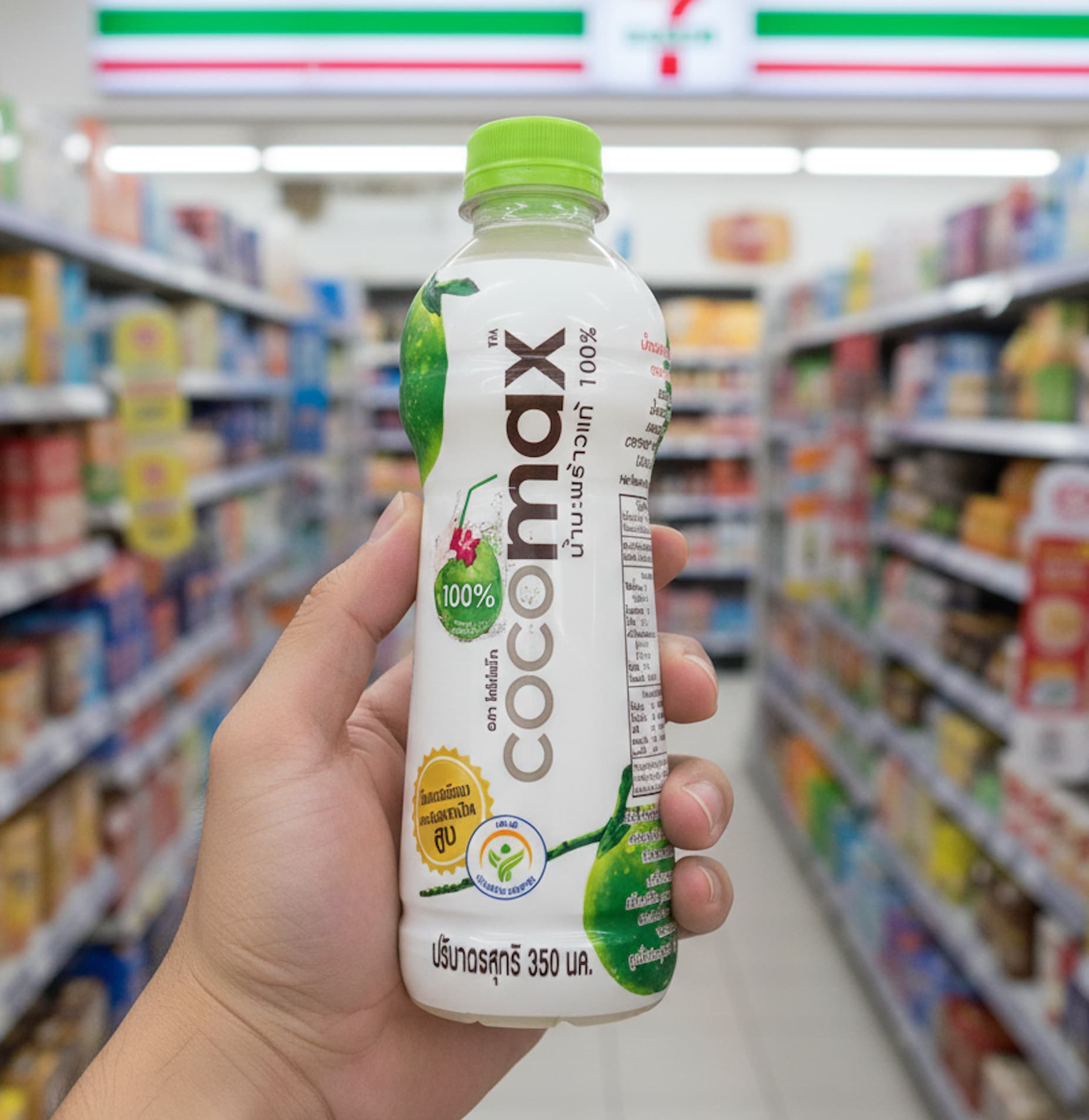 A bottle of Cocomax 100% Coconut Water held inside a Thai 7-Eleven store.