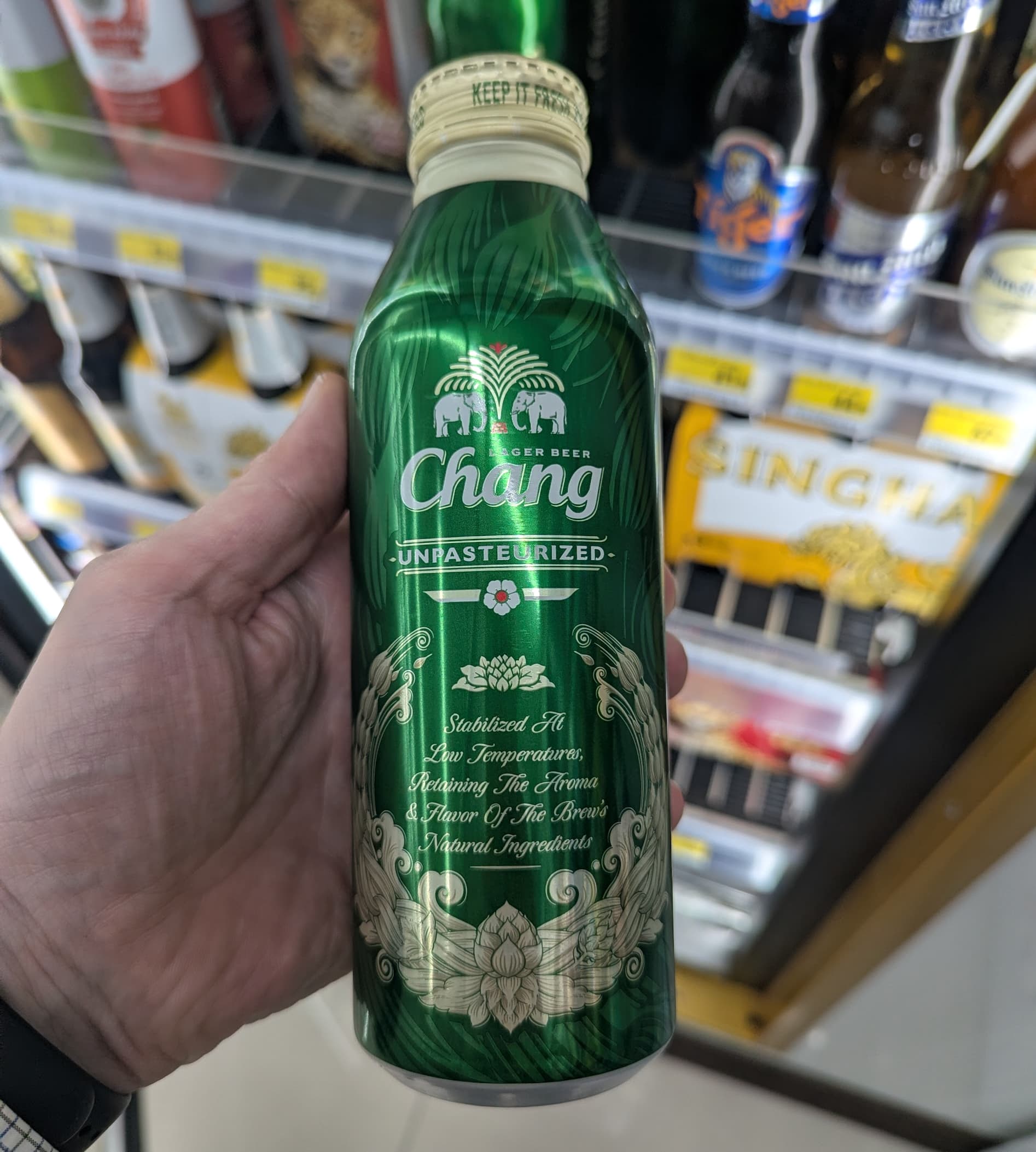 A cold bottle of Chang Unpasteurized lager beer from 7-Eleven Thailand.