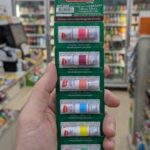 A display of Poy-Sian Mark II nasal inhalers in various colors at a 7-Eleven in Thailand.