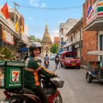 A photo of a 7-Eleven Thailand delivery rider on a motorbike.