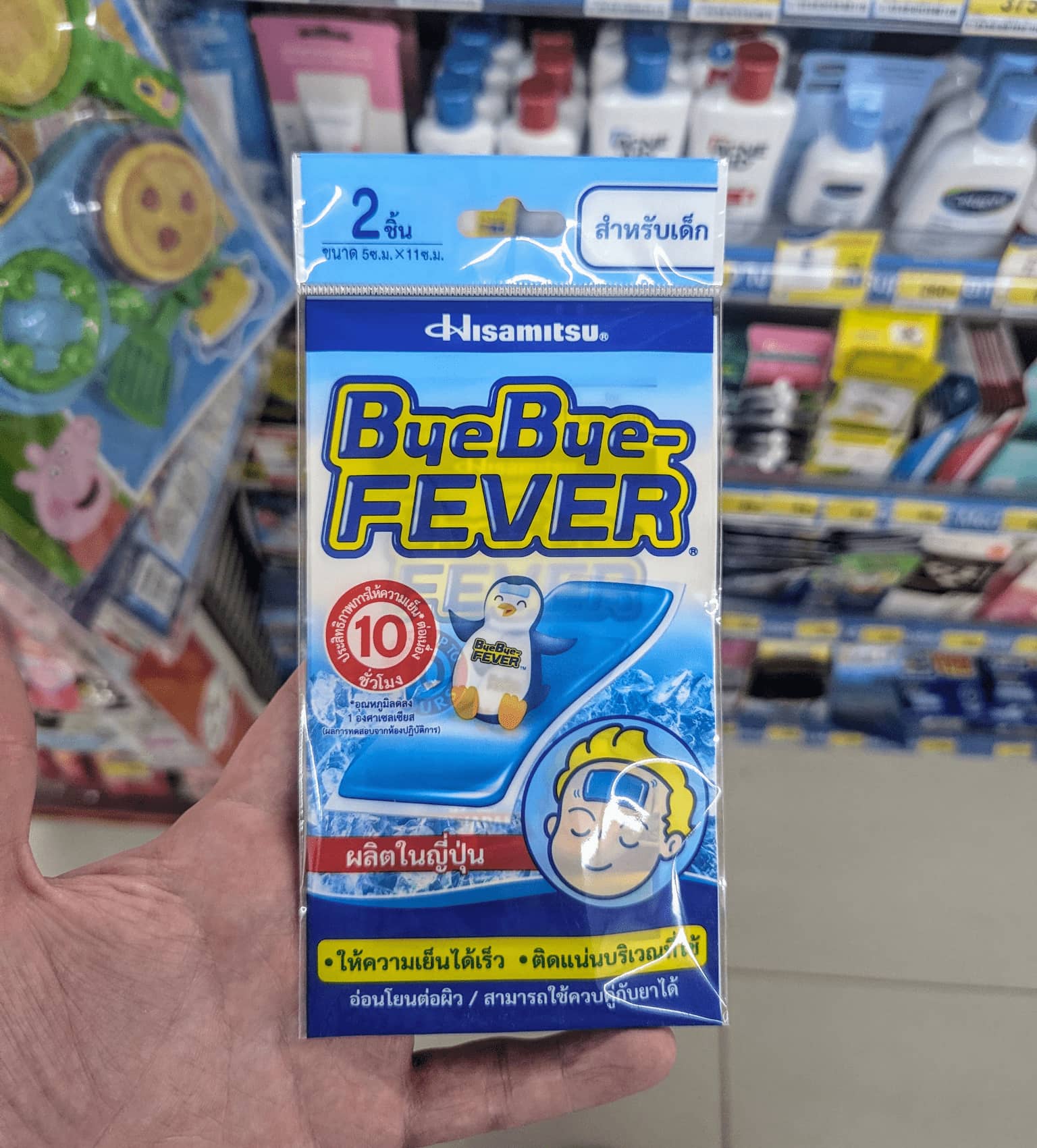 A packaged box of Hisamitsu ByeBye-Fever cooling gel sheets held inside a store in Thailand.