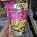 Commercial Bottled Green Tea: High Sugar in a Plastic Shell A pink pouch of Koh-Kae Plus Salted & Roasted Cashew Nuts held inside a 7-Eleven store in Thailand.