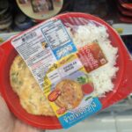 A white plastic tray of Ezygo Stir Fried Shrimp Omelette with Rice from 7-Eleven Thailand.