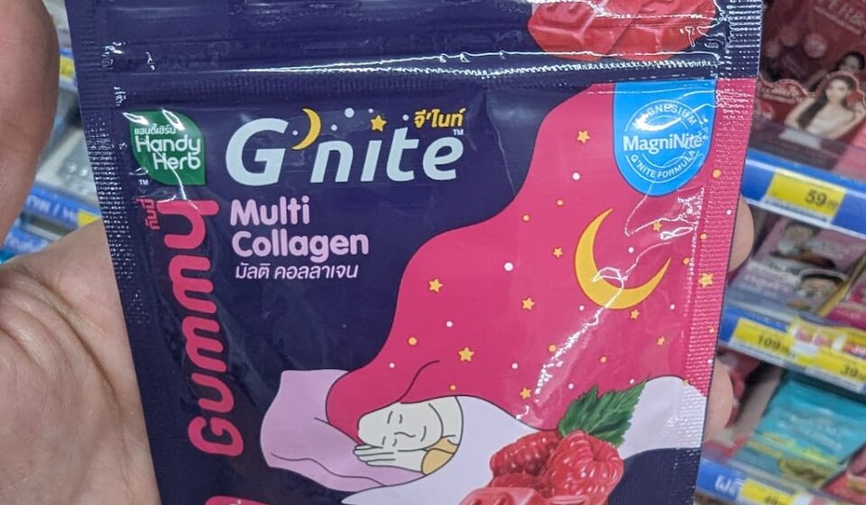 HandyHerb G’nite Multi Collagen Gummy: Deep Relaxation with a Cosmetic Bonus A hand holding a purple and pink sachet packet of HandyHerb G'nite Multi Collagen Gummy inside a store in Thailand.