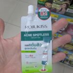Nongshim Shin Ramyun Toomba Aespa Edition: A Silky, Creamy Twist on Legendary Korean Heat A hand holding a white and green sachet of Rojukiss Acne Spotless Serum Gel with a screw cap inside a store in Thailand.